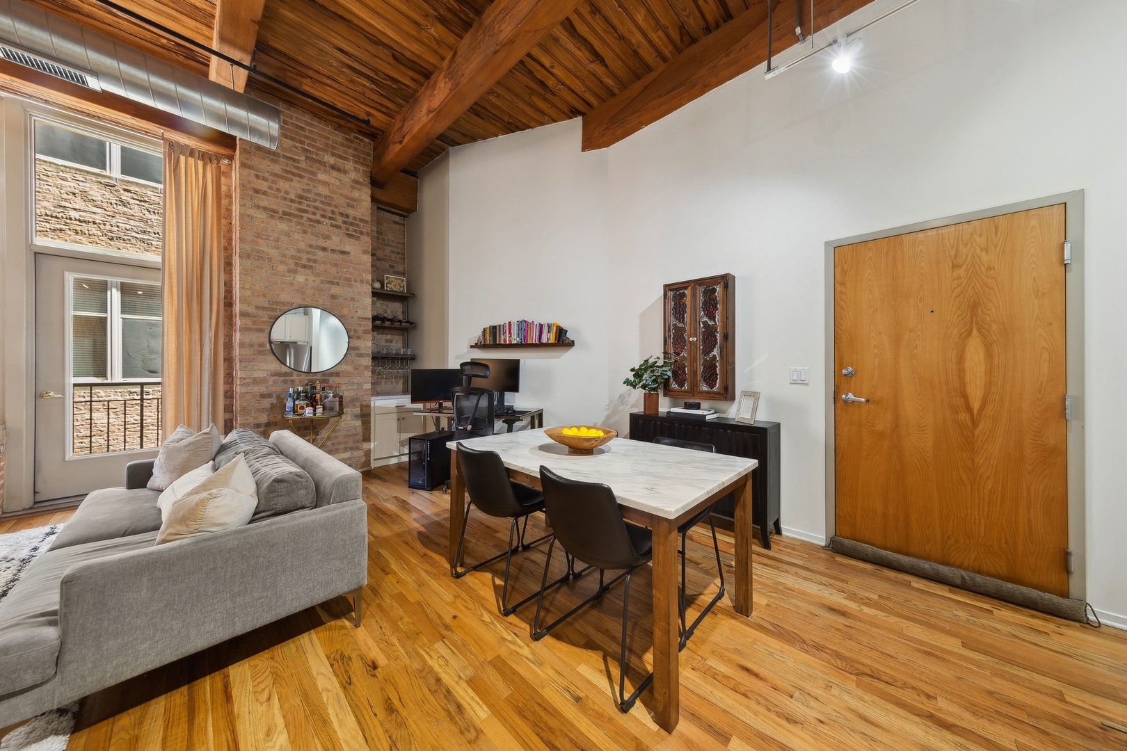 1500 West Monroe Street, Unit 306 Chicago, IL 60607 - Photo 7 of 13 a living room with furniture and wooden floor