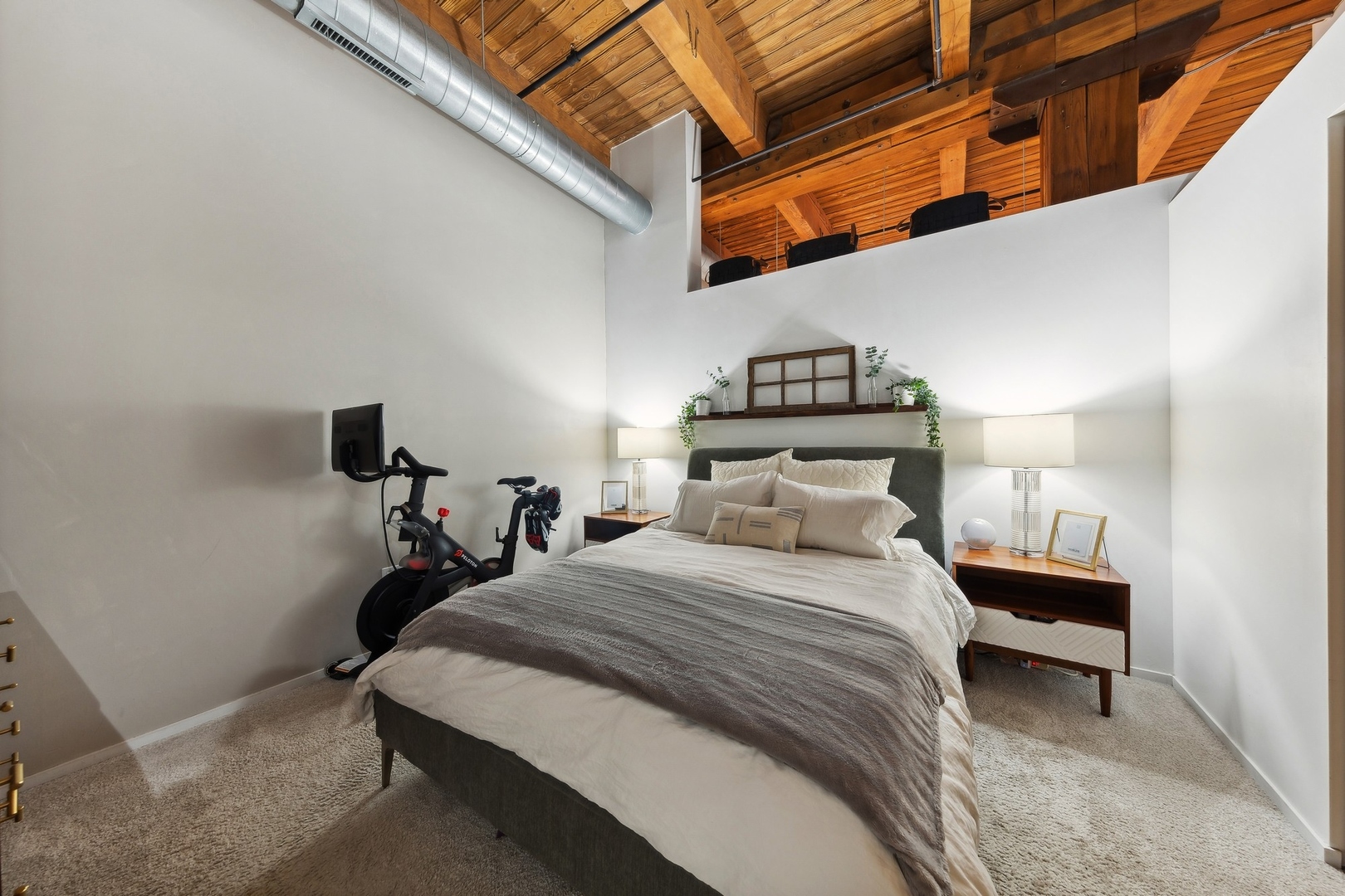 1500 West Monroe Street, Unit 306 Chicago, IL 60607 - Photo 8 of 13 a bedroom with a bed and a lamp with the view of a small room