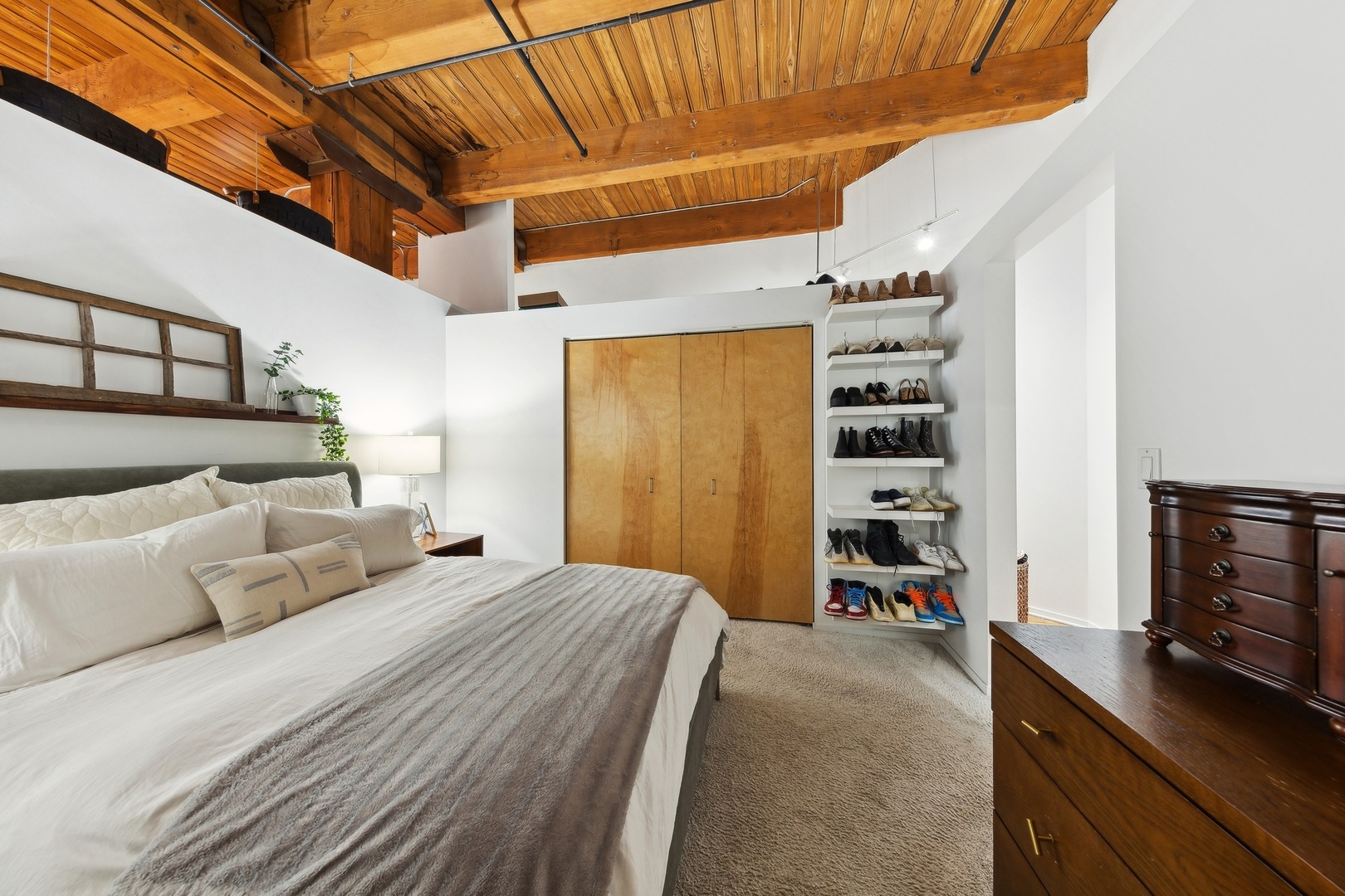 1500 West Monroe Street, Unit 306 Chicago, IL 60607 - Photo 9 of 13 a bedroom with a bed and a flat tv screen on wall