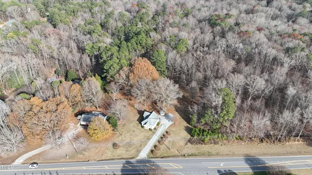 a view of a dry yard with trees