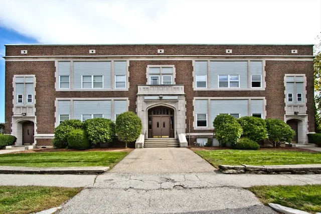 a front view of a building with garden