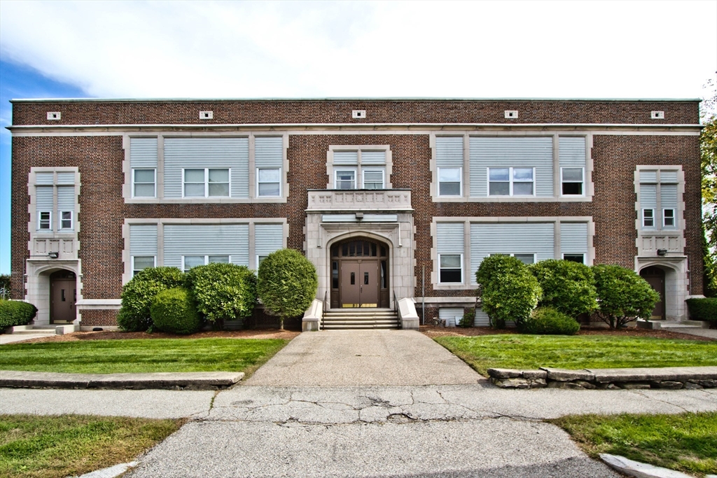 a front view of a building with garden