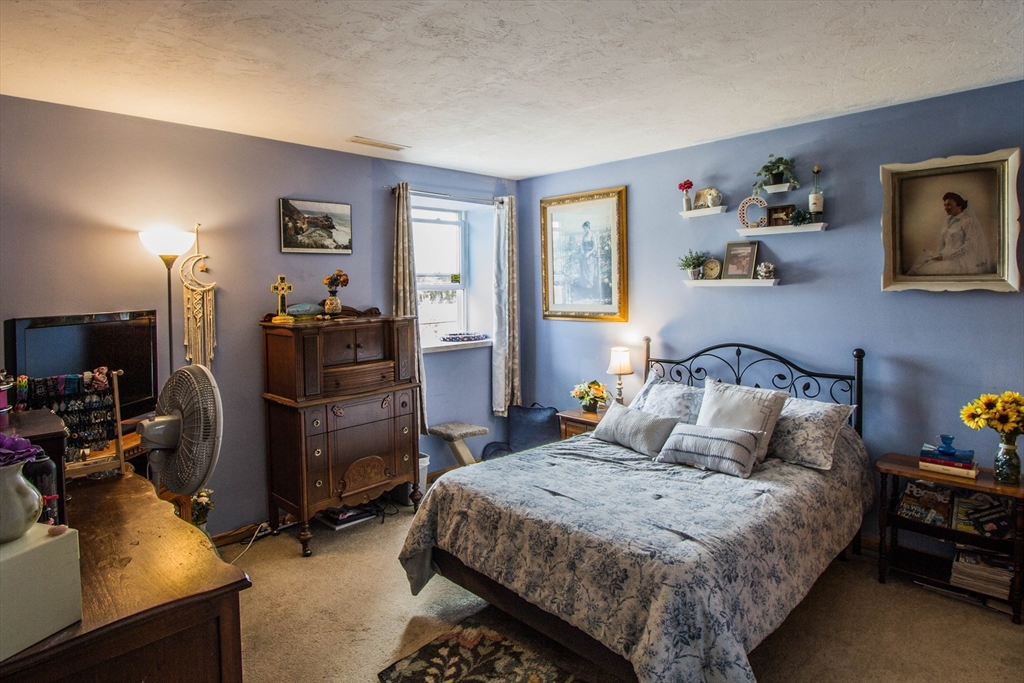 21 Middlesex Avenue, Unit 102 Worcester, MA 01604 - Photo 11 of 21 a bedroom with a bed and furniture