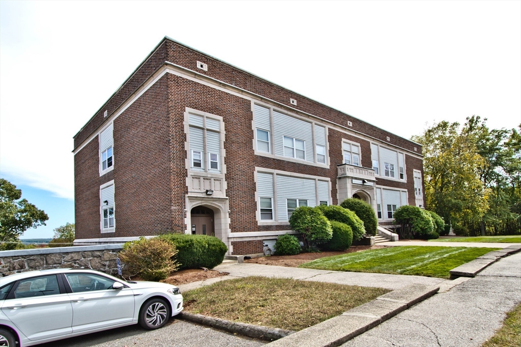 21 Middlesex Avenue, Unit 102 Worcester, MA 01604 - Photo 2 of 21 a car parked in front of a brick house