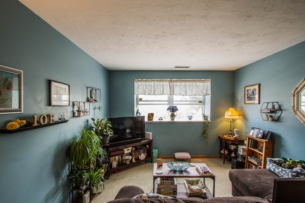 21 Middlesex Avenue, Unit 102 Worcester, MA 01604 - Photo 3 of 21 a living room with furniture and a window