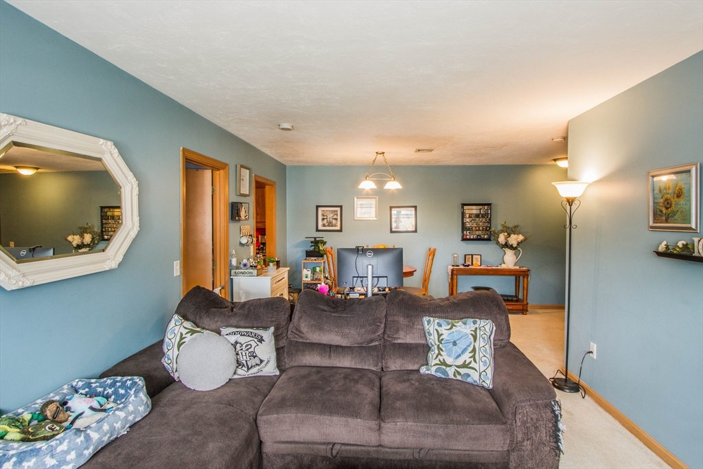 21 Middlesex Avenue, Unit 102 Worcester, MA 01604 - Photo 5 of 21 a living room with furniture and a wooden floor