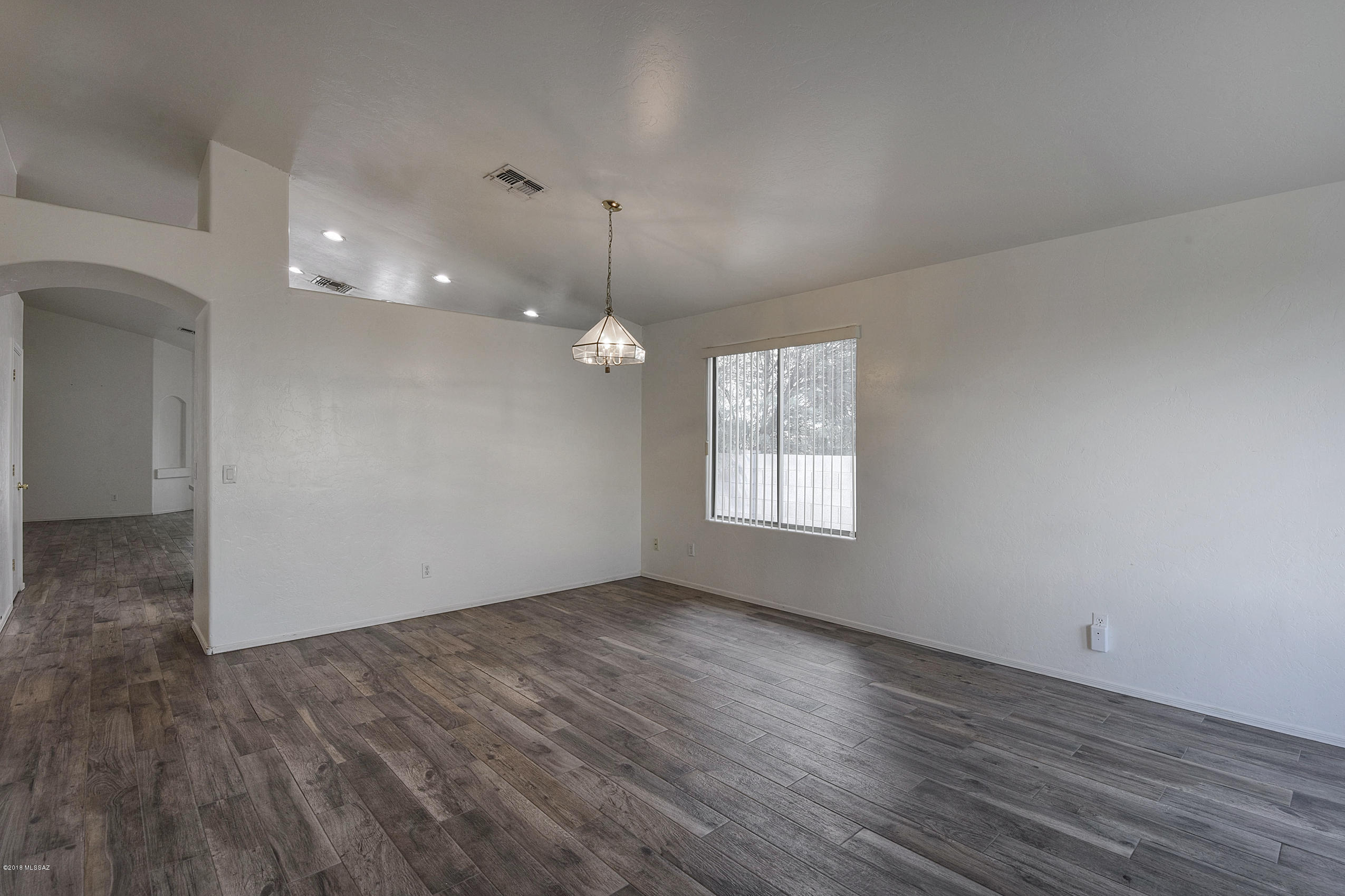 4328 South Valley Road Tucson, AZ 85714 - Photo 10 of 29 an empty room with wooden floor and windows