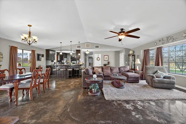 a kitchen with stainless steel appliances granite countertop a refrigerator stove and sink