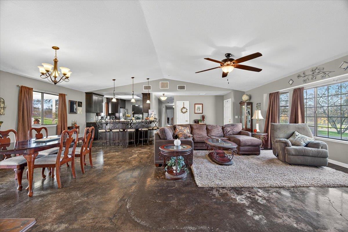 35102 Quail Oak Road Auberry, CA 93602 - Photo 16 of 61 a living room with furniture a chandelier and a dining table