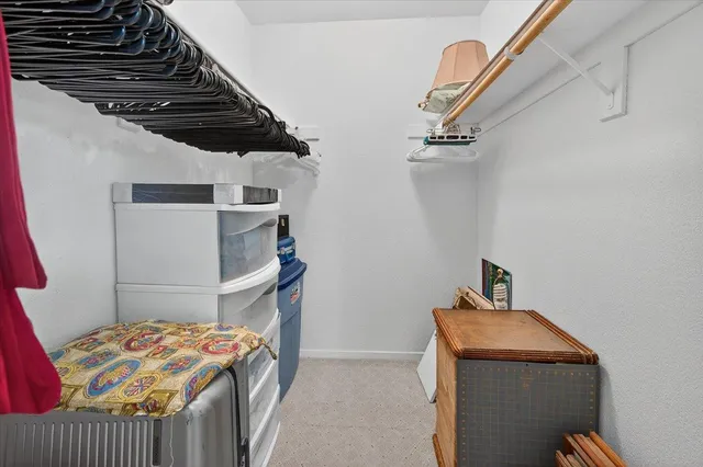 a view of a livingroom with furniture and a chandelier fan