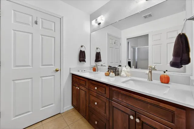 a spacious bathroom with a granite countertop sink and a mirror