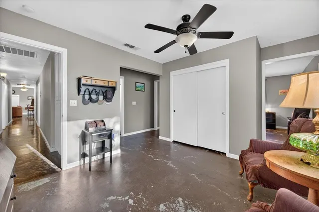 a living room with furniture a chandelier and a rug