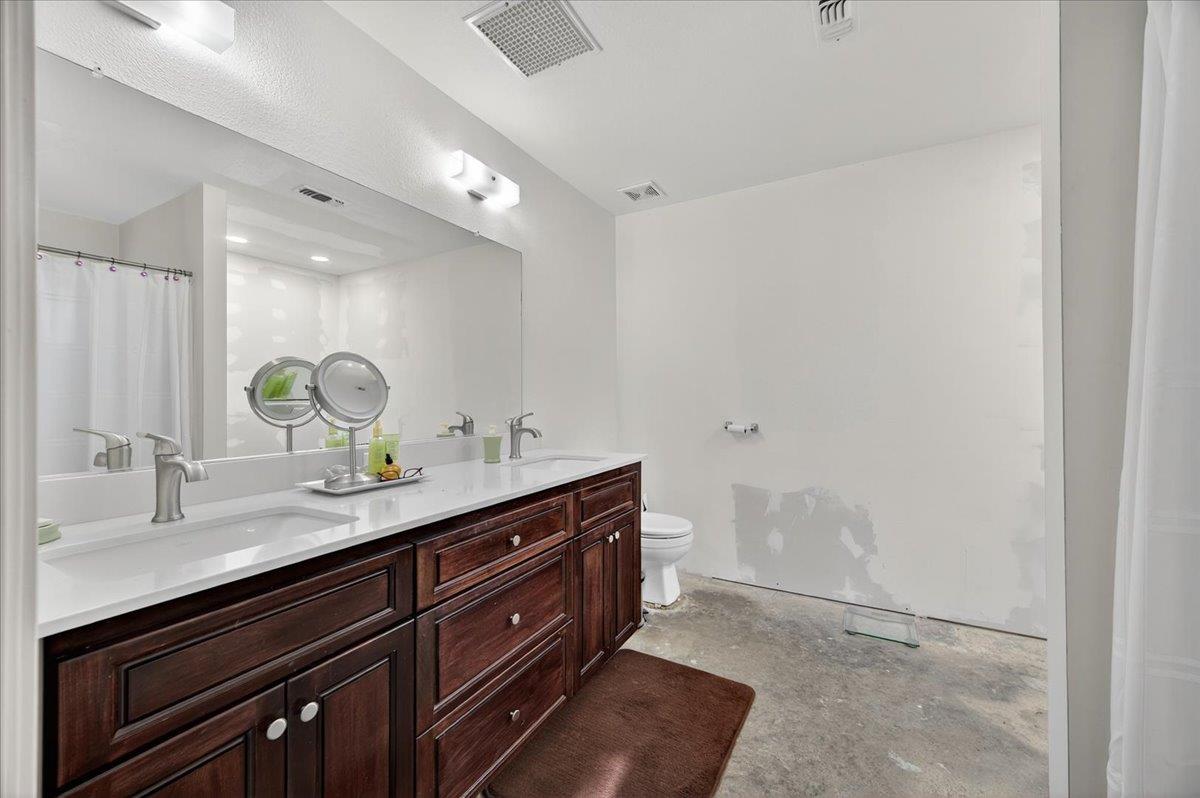 35102 Quail Oak Road Auberry, CA 93602 - Photo 37 of 61 a spacious bathroom with a granite countertop sink and a mirror