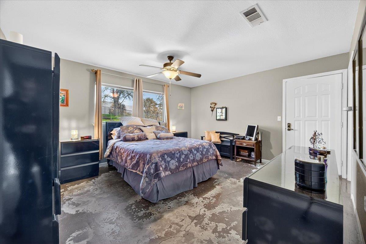 35102 Quail Oak Road Auberry, CA 93602 - Photo 38 of 61 a spacious bedroom with a bed a couch and a chandelier