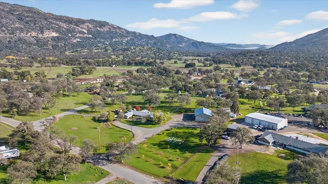 a view of a house with a yard and a mountain view