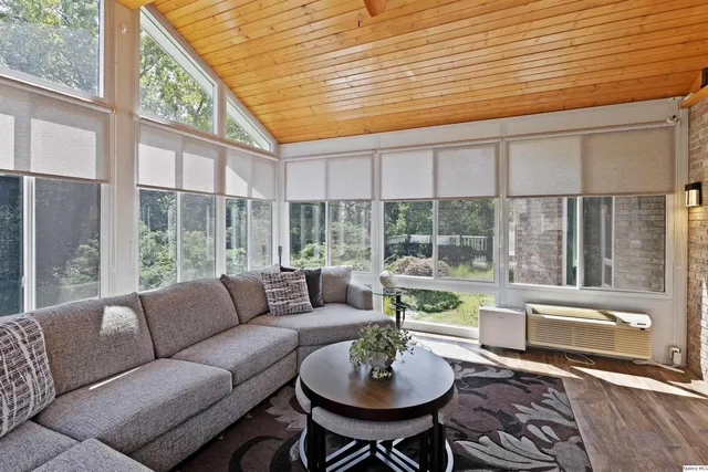 a backyard of a house with a yard and outdoor seating