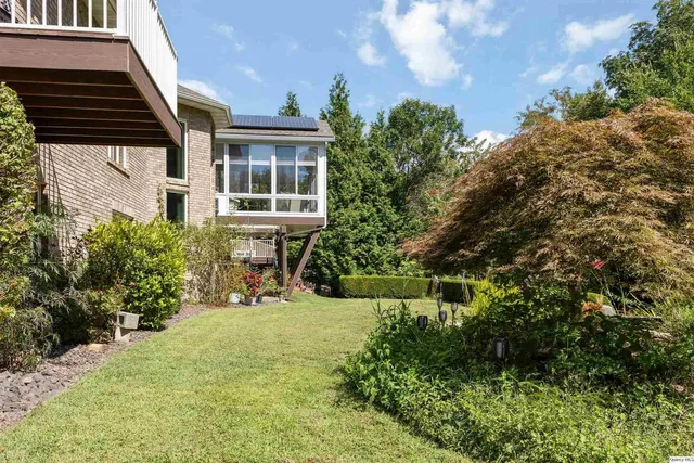 a view of a chairs and table in the balcony