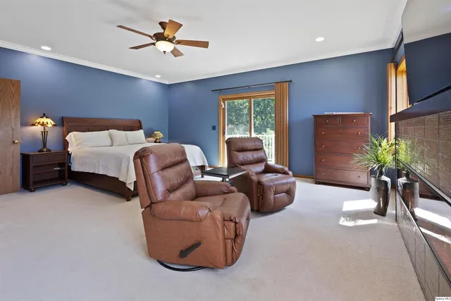 a bed room with bed and potted plant