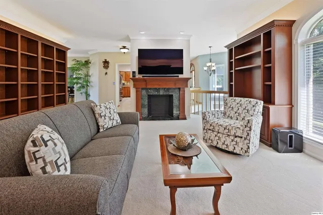 a living room with furniture a flat screen tv and a fireplace