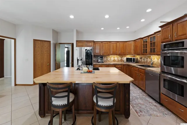 a kitchen with a table chairs refrigerator and cabinets