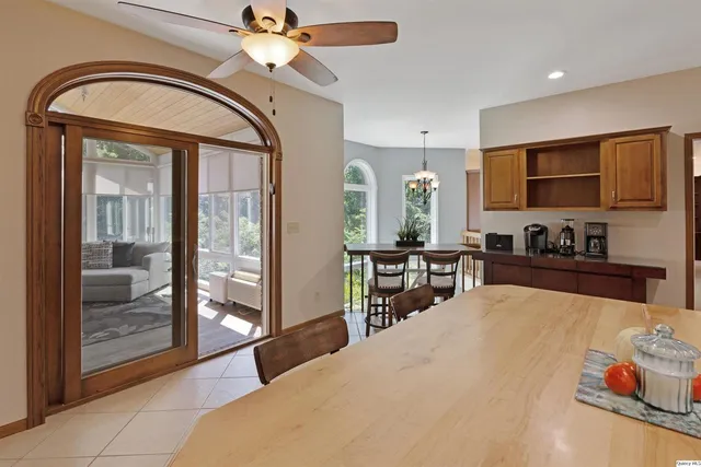 a living room with furniture a flat screen tv and a large window