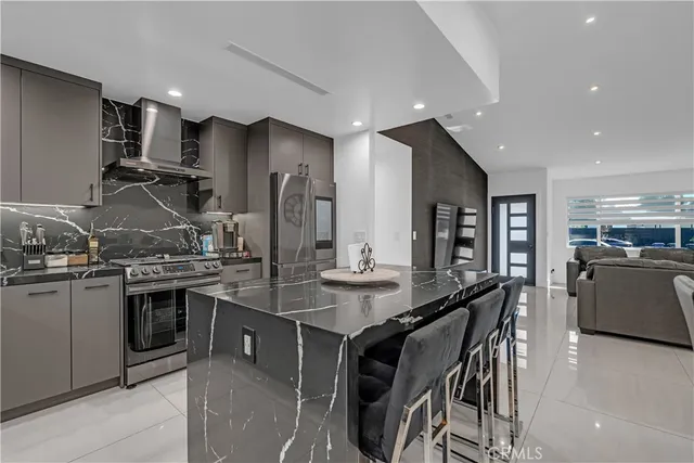 a kitchen with stainless steel appliances granite countertop a stove and a refrigerator