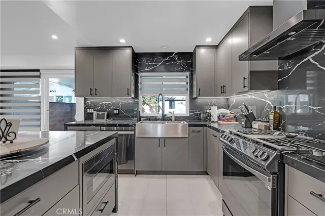 a kitchen with stainless steel appliances granite countertop a stove and a sink