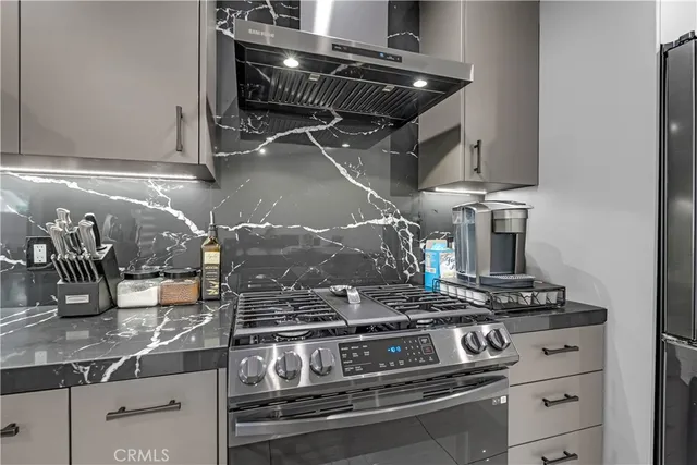 a stove top oven sitting inside of a kitchen