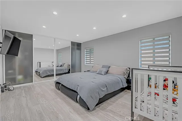 a bedroom with a bed and a couch