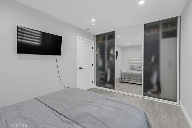 a bedroom with a bed and a television