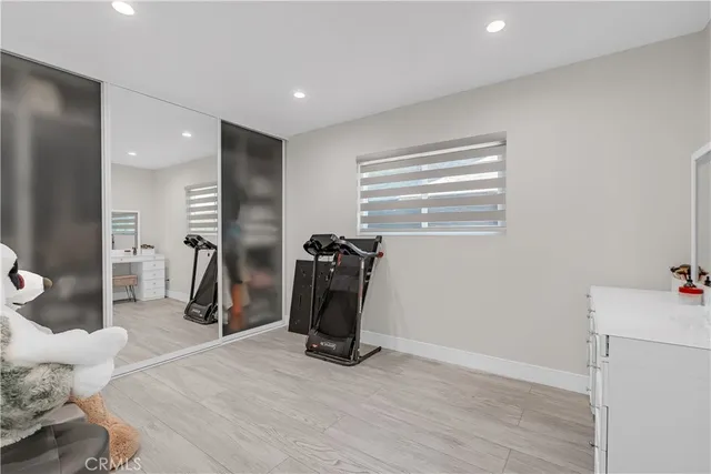 a view of a room with gym equipment and a window