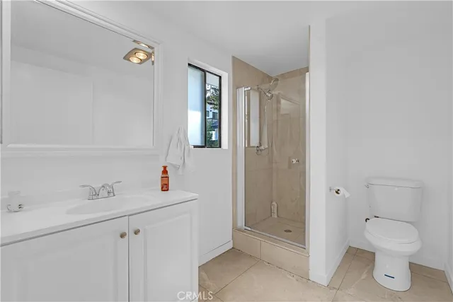 a bathroom with a toilet sink and shower