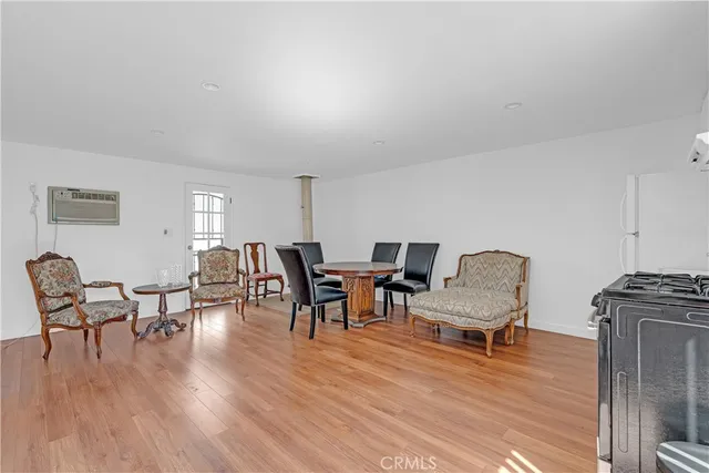 a view of a dining room with furniture wooden floor and a rug