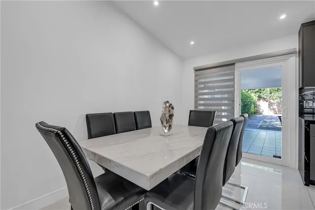 a view of a dining room with a table and chairs
