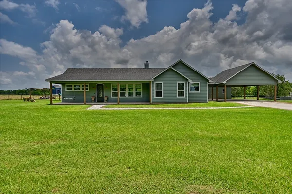 a front view of house with yard and green space
