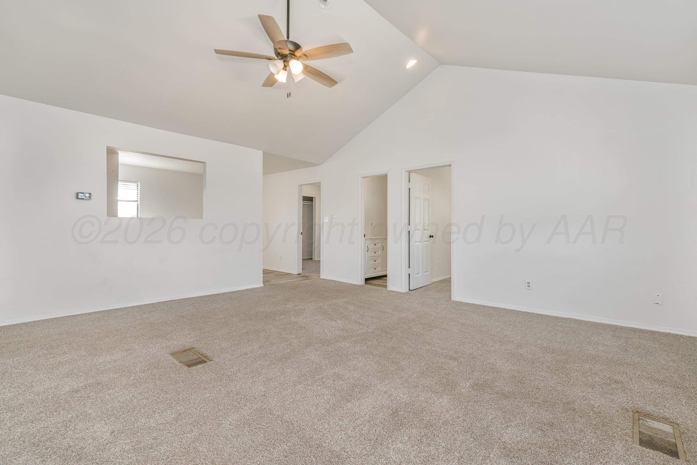 910 8th Avenue Canyon, TX 79015 - Photo 15 of 22 an empty room with a ceiling fan and a window
