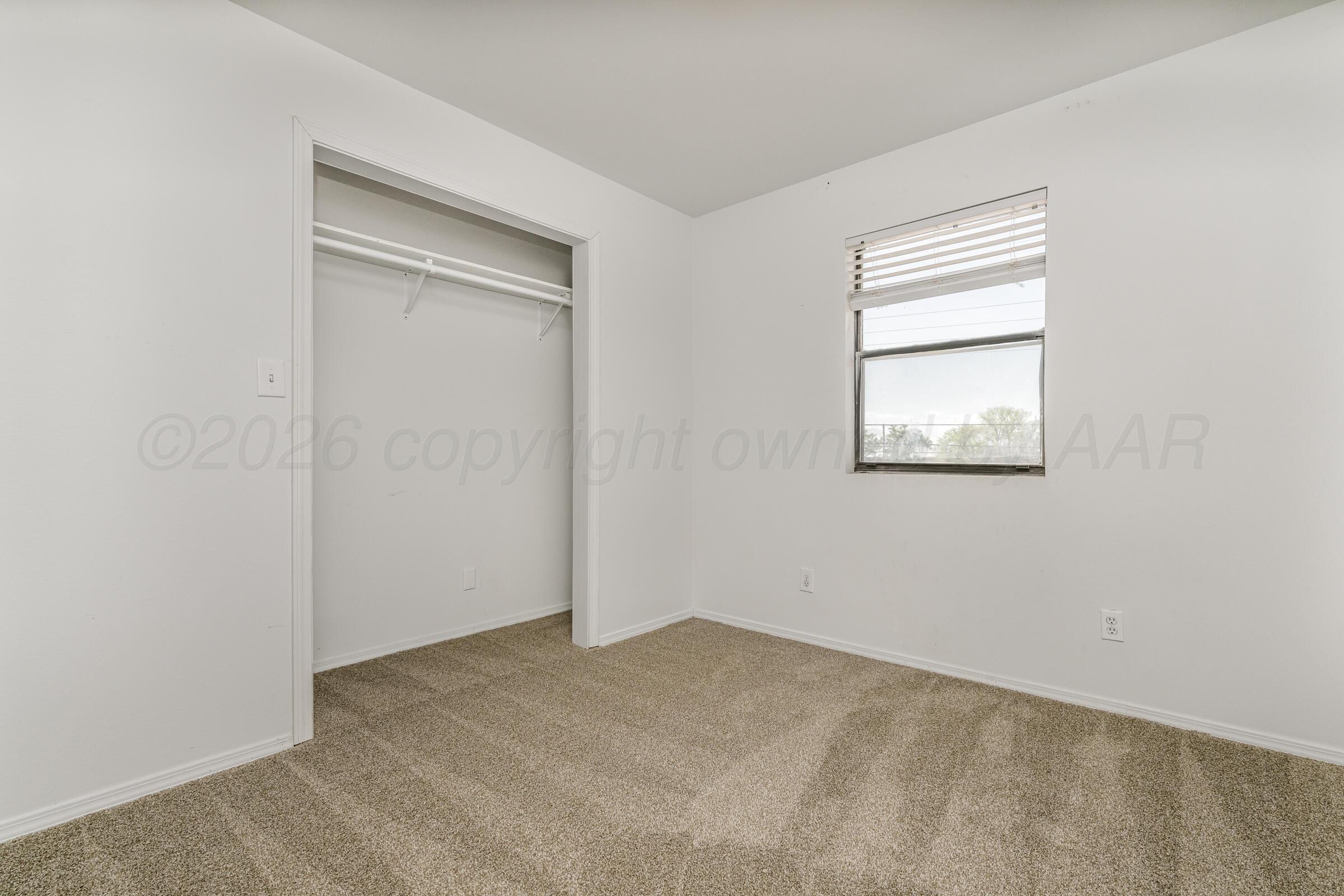 910 8th Avenue Canyon, TX 79015 - Photo 16 of 22 an empty room with windows and closet