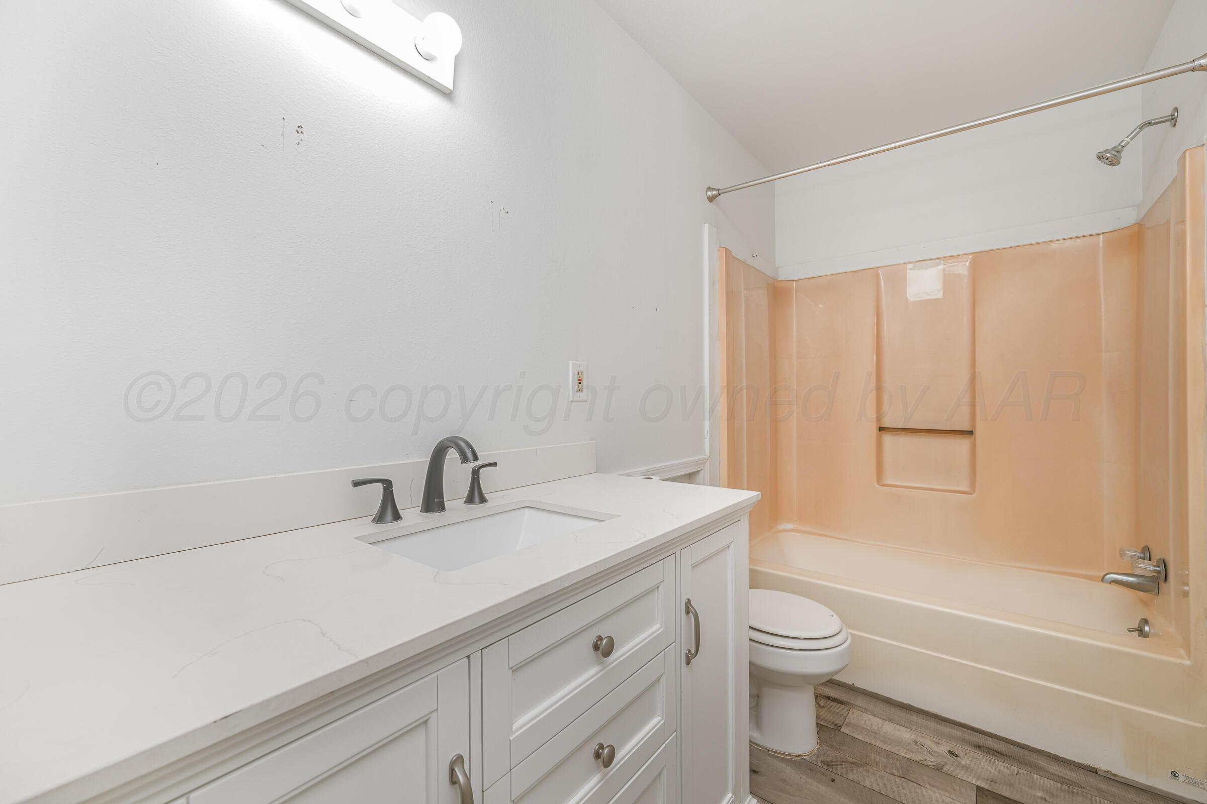 910 8th Avenue Canyon, TX 79015 - Photo 17 of 22 a bathroom with a sink a toilet and shower