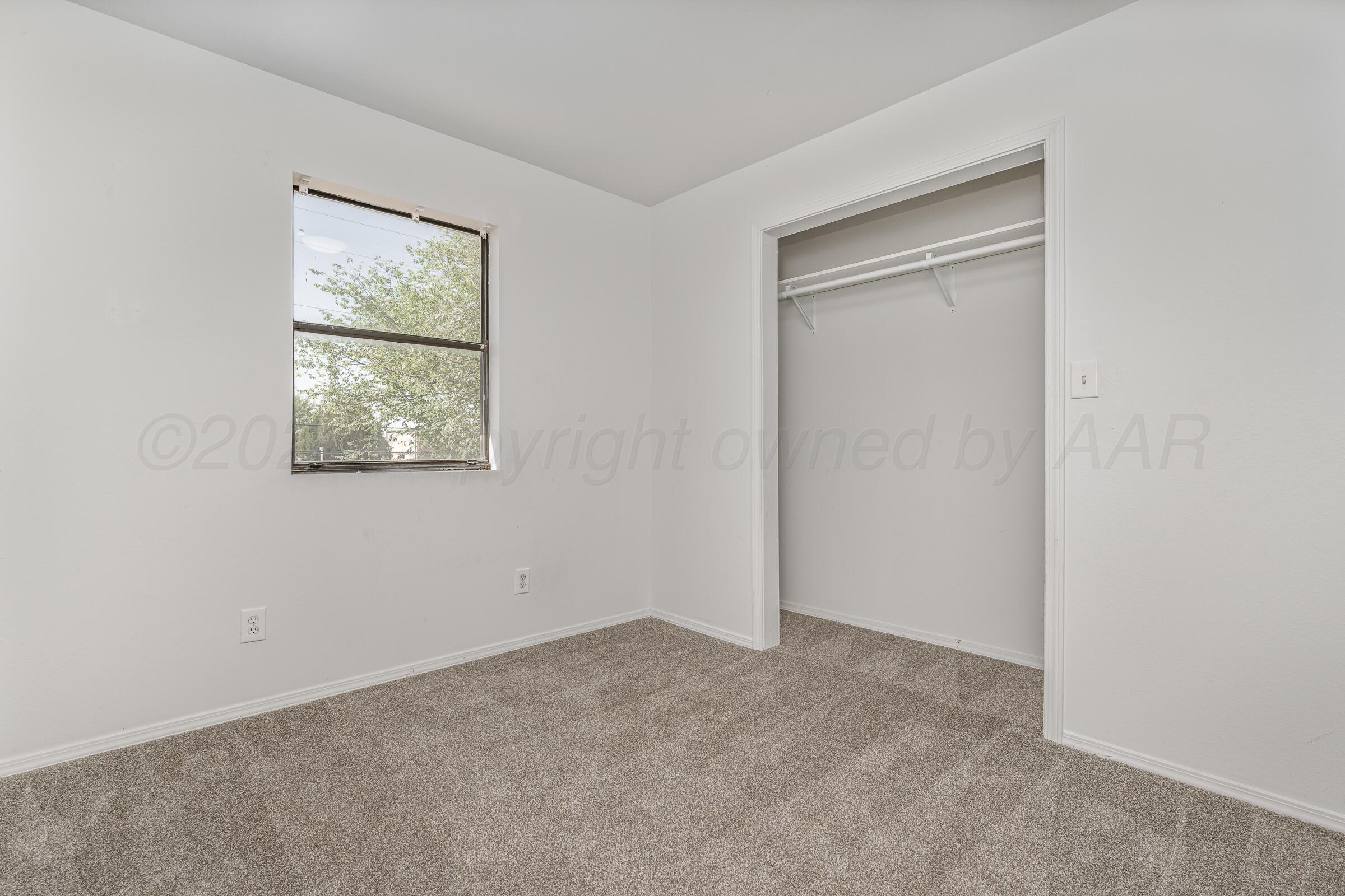 910 8th Avenue Canyon, TX 79015 - Photo 18 of 22 an empty room with windows and closet