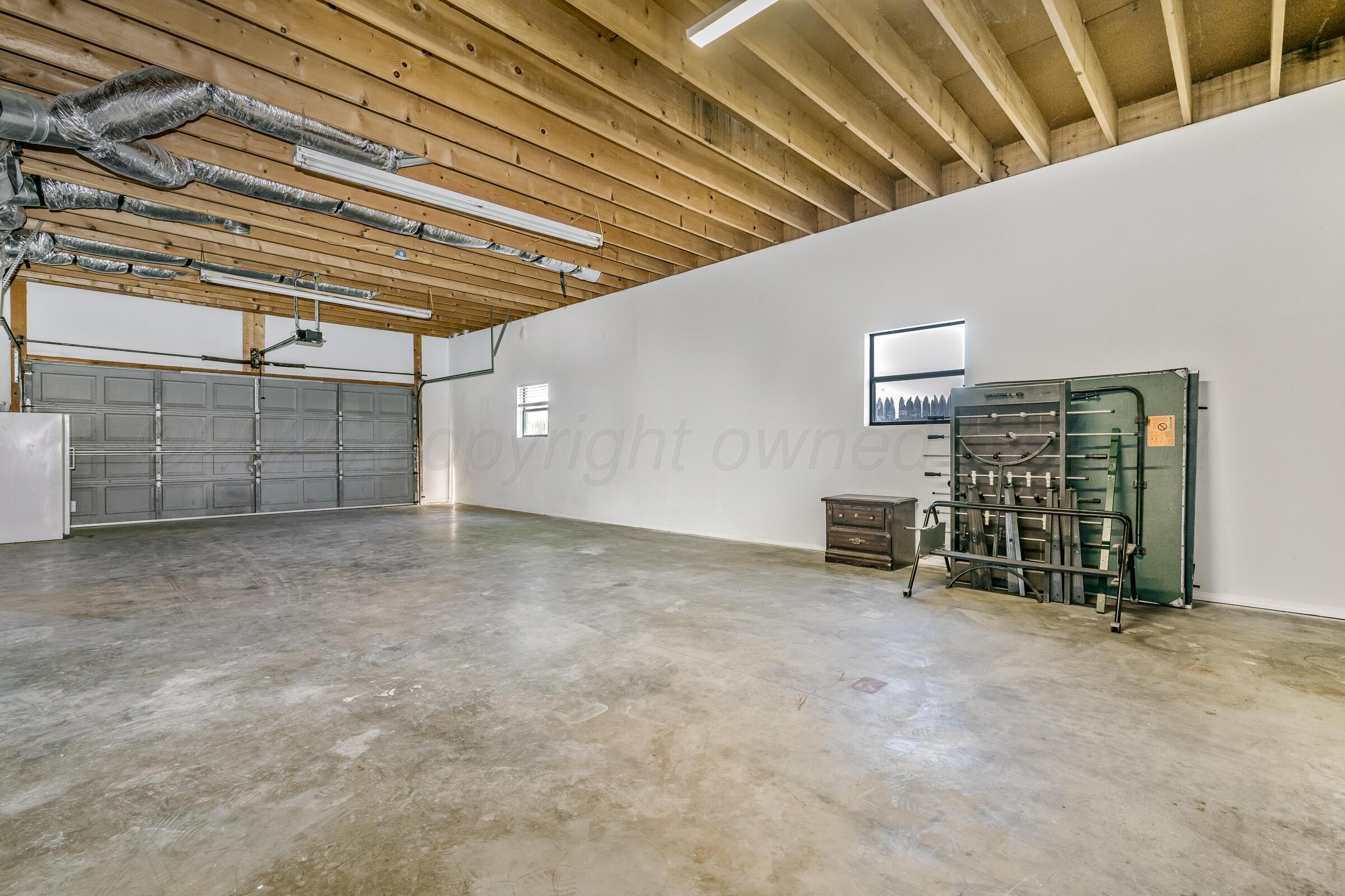 910 8th Avenue Canyon, TX 79015 - Photo 7 of 22 a view of an empty room with white wall and a ceiling fan