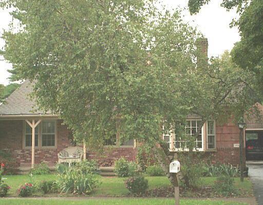 front view of a house with a tree
