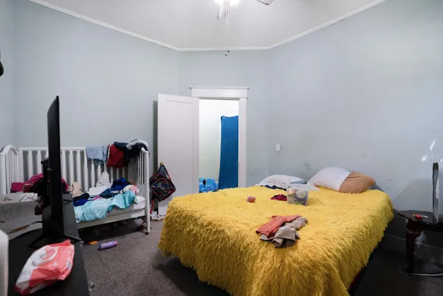 a living room with furniture and a baby crib