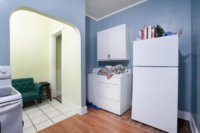 a kitchen with a refrigerator and a stove top oven