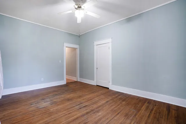 an empty room with wooden floor and closet