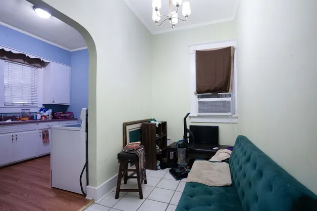 a living room with furniture a window and a flat screen tv