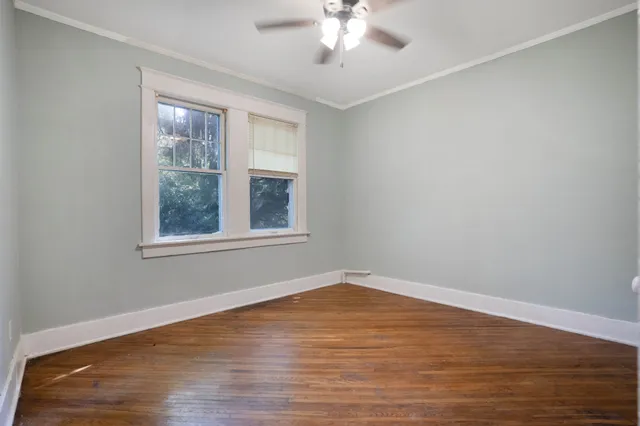an empty room with wooden floor and closet
