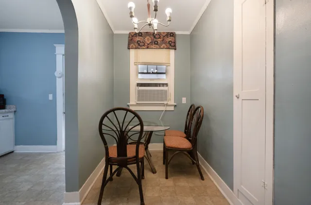 a kitchen that has a stove and a table in it