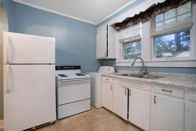 a view of a house with a yard and tree