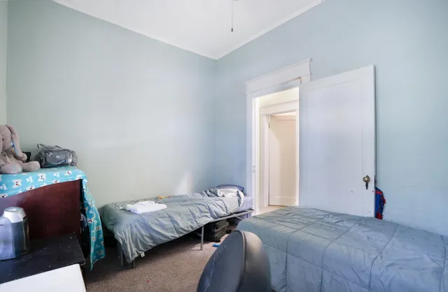 a bed room with a bed and a chair