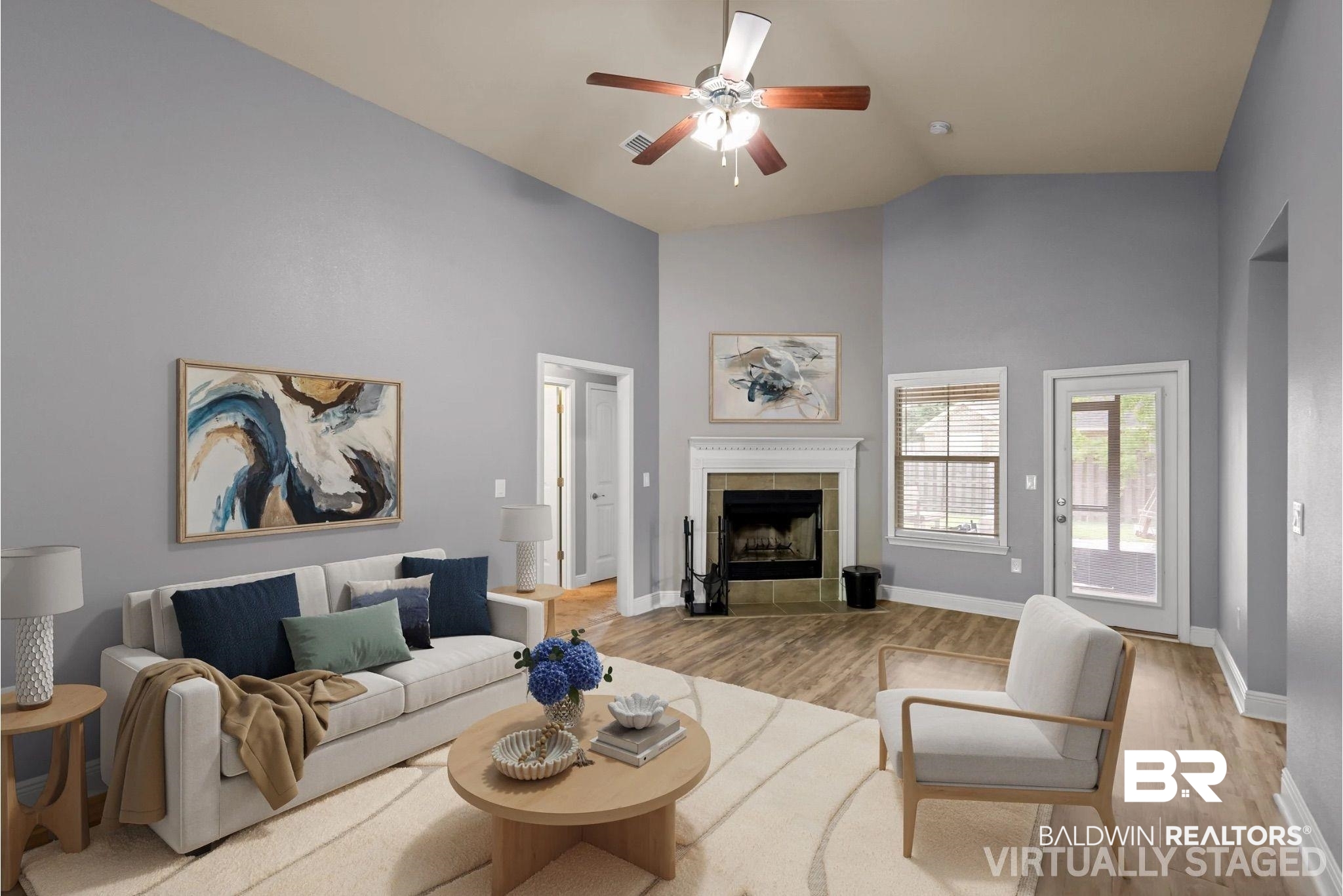 22076 Garland Loop Silverhill, AL 36576 - Photo 26 of 27 Virtually Staged, Vaulted ceiling living area featuring a central ceiling fan, wood-finish flooring, and a fireplace with a mantel